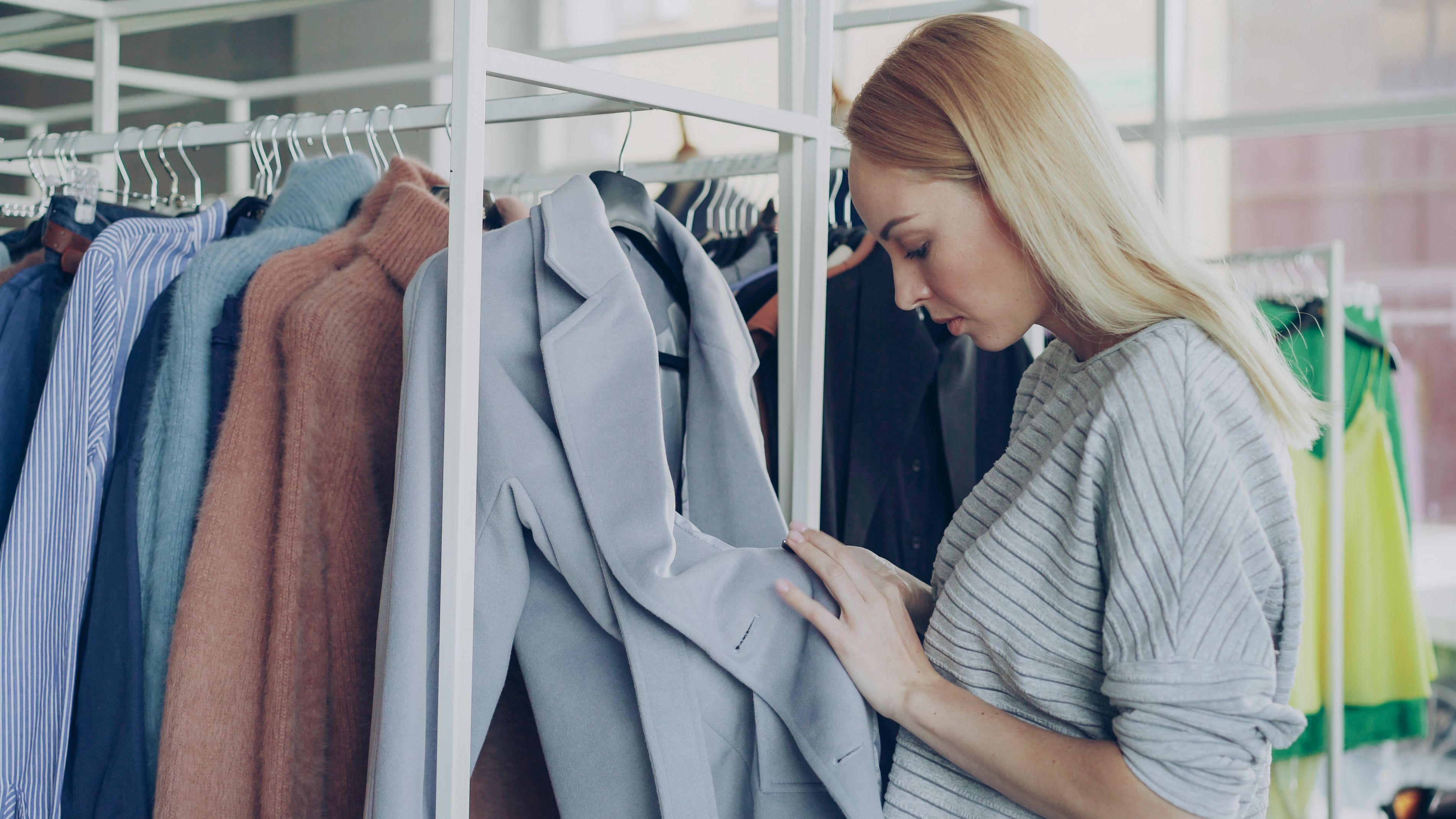 A woman browsing clothes on a clothing rack